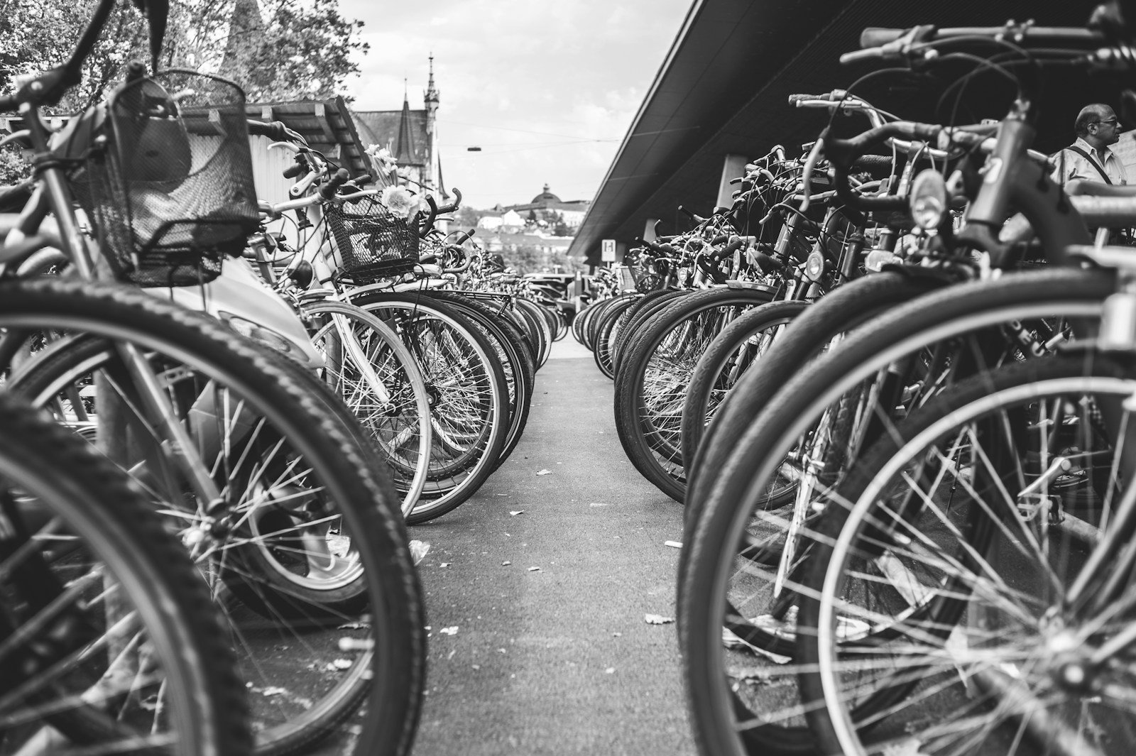 grayscale photo of bicycle parked on the side of the road